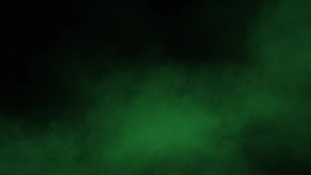 Green smoke and dust on a black background. Fast-moving fog and smog 4K video