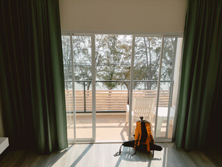 Fototapeta premium Quiet travel preparations in sunlit hotel room with nature nearby
