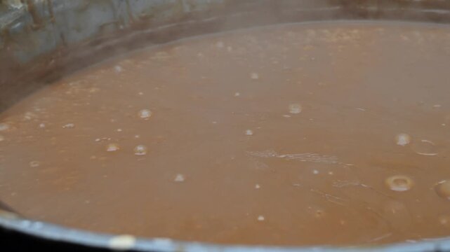 Traditional Sumalak Cooking in Large Cauldron. Navruz Spring Festival in Uzbekistan