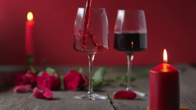 Elegant red wine pouring into a stemware glass on a rustic wooden table. Romantic atmosphere with red candles and roses. Perfect for Valentine's Day, celebrations, and cozy evenings