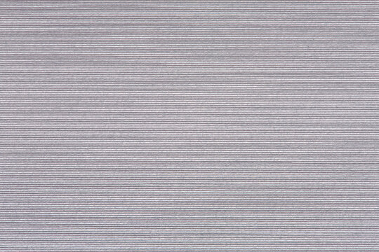 Embossed white paper with paralel lines pattern.