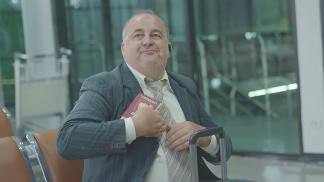 passenger at airport terminal departure platform airline transport.
businessman in airport terminal airport waiting area showing tired or bored expressions before boarding.
