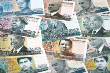Cambodian riel money bills pile on table. Cambodia banknotes of KHR currency close up. Concept of business, economy and banking in Cambodia © mehaniq41