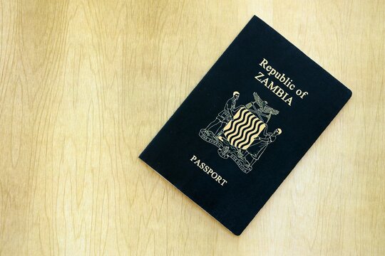 Zambian passport on table close up. Official identification document book for citizens of Zambia. Concept of travel and tourism in Zambia