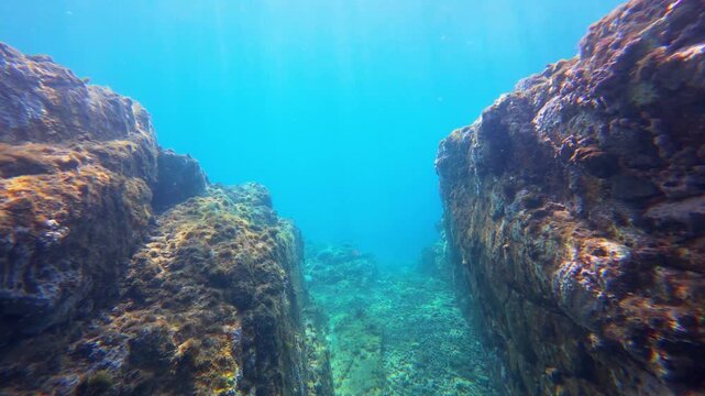 Sunlight refracting through clear turquoise water onto a rocky volcanic reef on Pr&iacute;ncipe Island, S&atilde;o Tom&eacute; and Pr&iacute;ncipe.