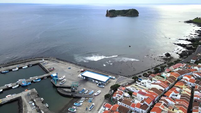 Cinematic aerial drone view of the volcanic islet of Vila Franca do Campo near S&atilde;o Miguel Island in the Azores, Portugal. The ring-shaped crater forms a natural lagoon surrounded by dramatic cliffs an
