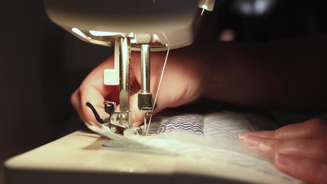 Sewing patchwork quilt with batting on sewing machine macro detail