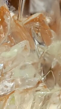 Pouring tea into glass of ice cubes, Cold Drink Cocktail, Cafe Restaurant Refreshment, Asian Caffeine Beverage, Slow Motion, Maco Shot