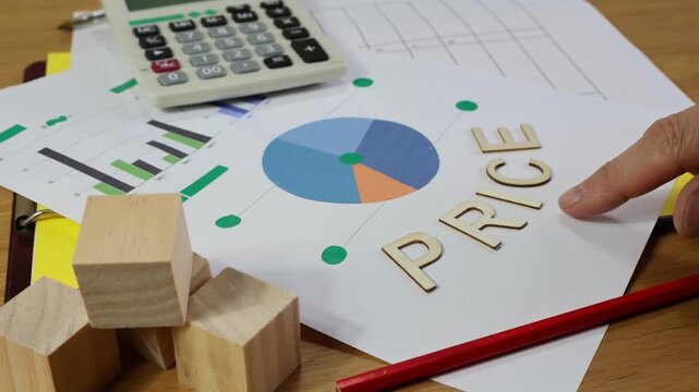 PRICE wooden sign with a man's hand pointing at the price sign as a sales concept with a graphic.