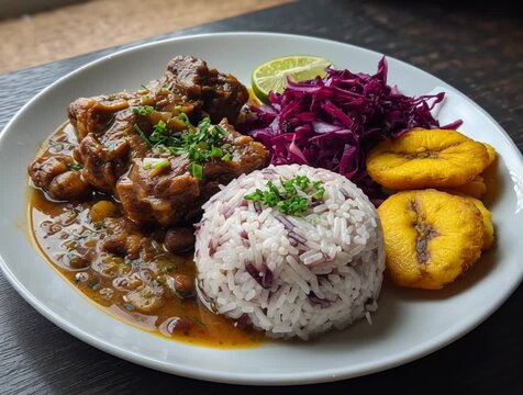 Delicious oxtail stew with rice and peas, fried plantains, and red cabbage