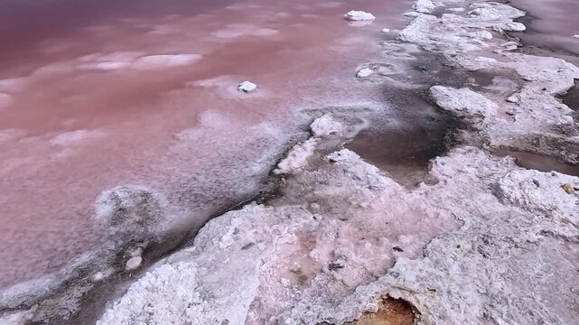 The Kuyalnik Estuary in the Odesa Oblast, Ukraine: black dust deposited on the shoreline covered with white table salt crystals of sodium chloride (NaCl); 