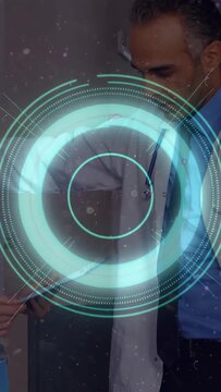 Vertical video: Medical doctor leaning reviewing chart staff handing gesturing blue HUD overlaying
