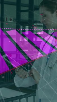 Vertical video: Doctor tapping tablet, reviewing medical data, causing magenta overlay and streaks