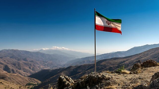 Iranian flag flying on a rocky mountain overlooking a valley