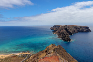 Obraz premium Panoramic view from the Miradouro das Flores viewpoint overlooking Ilhéu de Baixo and the blue ocean, Porto Santo, Portugal