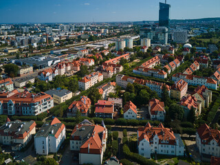 Obraz premium Aerial view of residential apartment buildings with red roofs and modern office skyscrapers including Olivia Star in the Oliwa district, Gdansk, Pomerania, Poland, Europe.