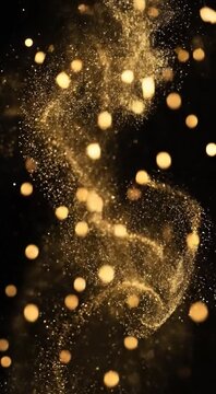 Golden particles swirl gracefully in dark space creating sparkling light effects