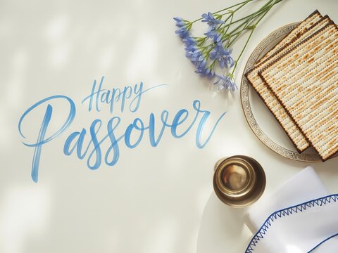 Happy passover celebration with matzah and flowers on a table setting