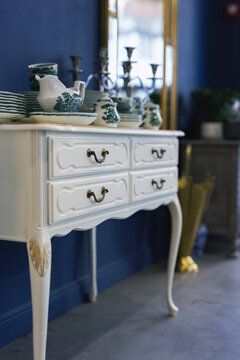 Elegant white vintage console table with porcelain tableware