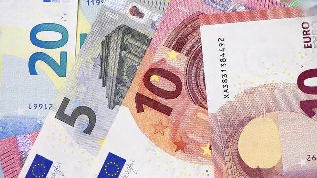 Viele Euro Banknoten fliegen zusammen auf einen Geldhaufen