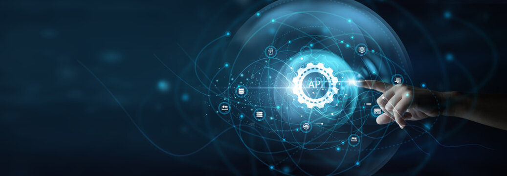 Technology professional holding laptop integrating platforms. API enables seamless communication between applications, improving connectivity, data exchange, and system scalability.