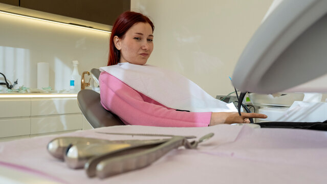 Female Patient Receiving Dental Treatment and Tooth Removal in Modern Dental Office