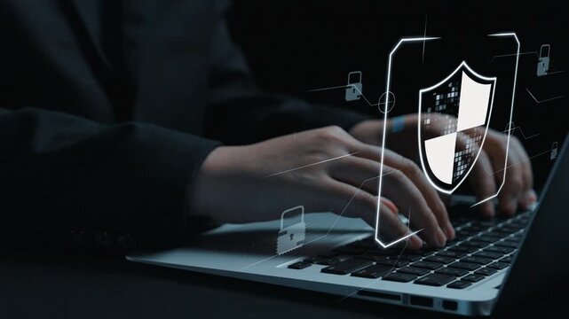 A pair of hands typing on a laptop keyboard is accompanied by a digital shield graphic symbolizing cybersecurity and online protection in a technology-driven world. Qubit