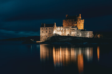 A nighttime view of Eilean Donan Castle, located in the Scottish Highlands. 