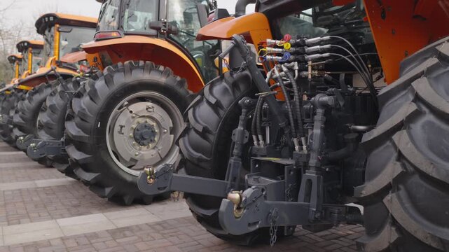 Tractors standing in row, showcasing heavy duty machinery ready for farming, embodying concepts of agriculture, innovation, and modern rural progress