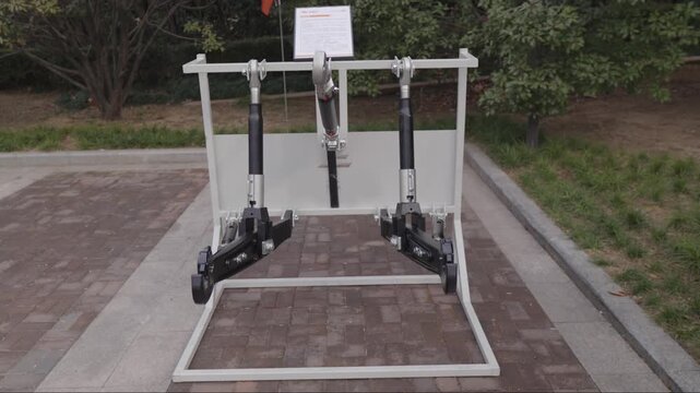 Heavy duty agricultural mechanical component mounted on display stand outdoors, industrial metal assembly used in tractor drivetrain or suspension system, engineering equipment for farm machinery