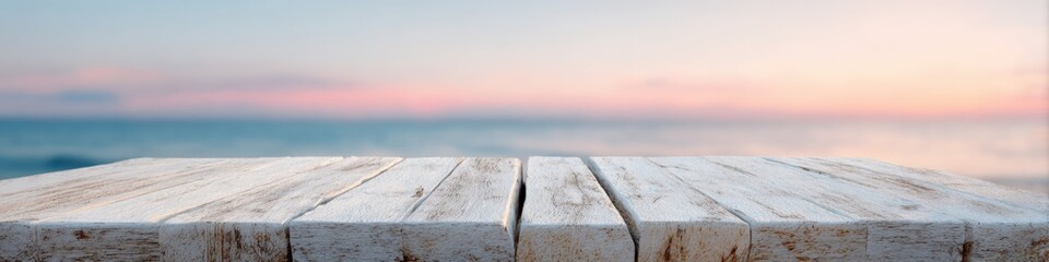 Fototapeta premium Weathered whitewashed wooden planks ocean horizon at pastel sunset with soft sky and gentle sea in background