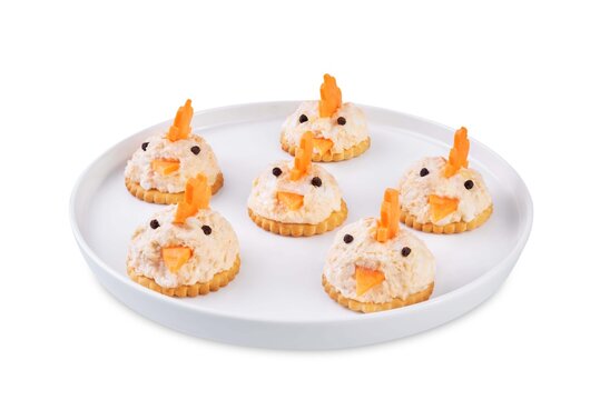 Salmon egg salad with crackers in the form of chicks in the plate on a white isolated background
