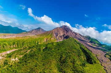 A view from a helicopter showing new vegetation on the north slopes of the Soufriere Hills volcano on the island of Montserrat on a bright sunny day © Nicola