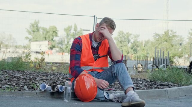 Builder suffering from fatigue and overwork on building site