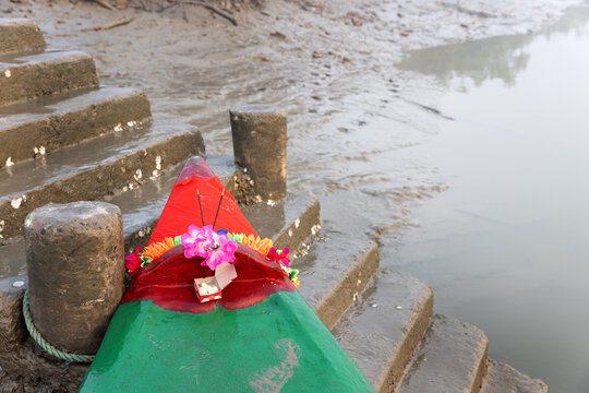 Boat head with flowers, sweets and Indian incense sticks after prayer and offering before starting safari trio at  at Sundarban tiger reserve, India