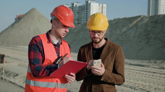 Man writing on documentation, director controlling work process