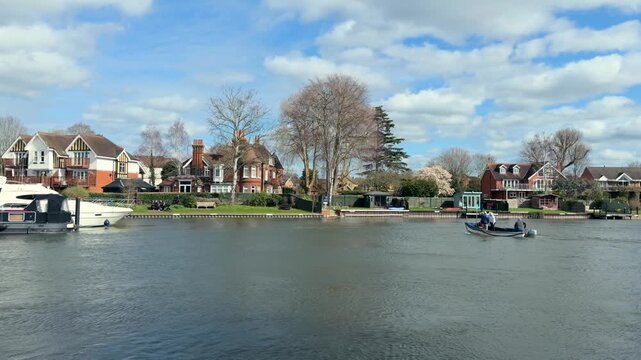 small boat crossing Bourne End, Marlow, Buckinghamshire, England. Spring Sunny day