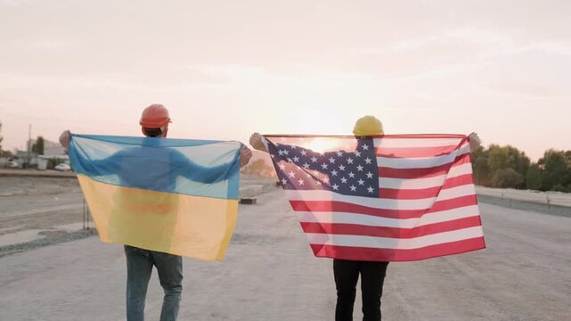 Multicultural team walking with flags on site
