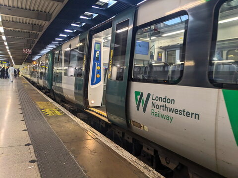A London Northwestern Railway train with its doors open at a platform in Euston Station, London