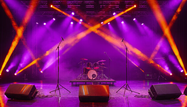 Unoccupied performance platform bathed in striking purple and orange spotlight projections, generating an electrically charged ambiance primed for upcoming musical acts.