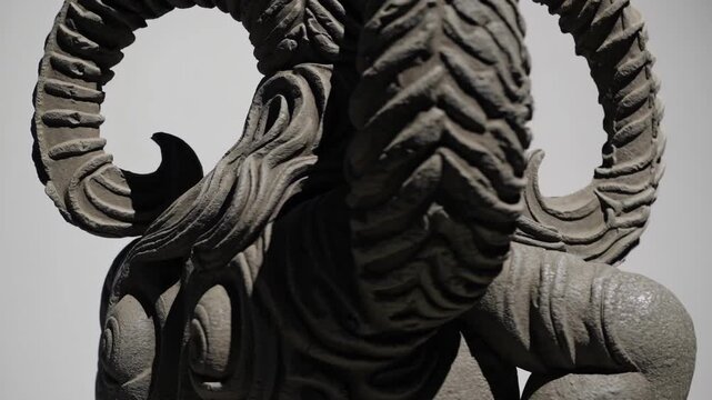 Weathered Granite Sculpture With Intricate Mythic Reliefs. Ancient Granite Sculpture Featuring Horned Divine Figure Illuminated Dramatically With Elaborate Mythological Carvings And Reliefs