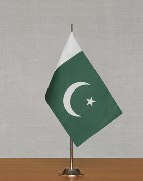 Table flag Pakistan on a blurred gray background