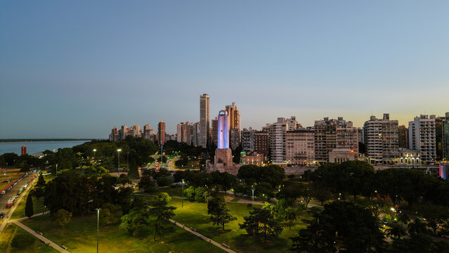 Panoramic aerial view of the National Flag Memorial in Rosario, Argentina, with the Paran&aacute; River and urban skyline at sunset