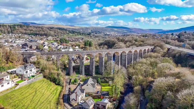 A receding aerial view flying away from the Cefn Coed Viaduct at Merthyr Tydfil, Wales, UK