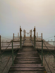 Fototapeta premium Uncertainty And Transition Wooden Pier Leading Into Foggy Water Representing Navigating Change Future Planning And Overcoming Challenges In Business And Life