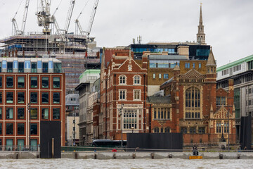 Fototapeta premium churches, office building and hotels in the skyline along the Queens Walk in London England UK