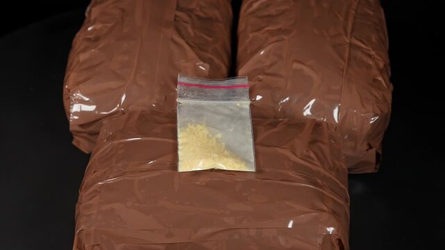 Drugs bricks or bags and packages display. Brick packs filled with drugs for smuggling and distribution. Cocaine Meth, Fentanyl and Opioids. Confiscated or seized toxic illegal substance view.