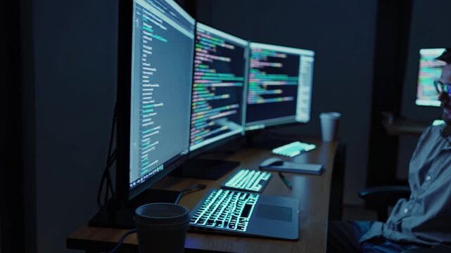 Developer Coding Latenight With Multiple Monitors Displaying Syntaxhighlighted Code, Blue Glow From Screens, Coffee Cup At Desk, Focused Debugging And Software Testing In Quiet Workspace