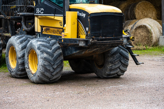 Uppsala, Sweden - August 10 2023: Large forestry forwarder machine with heavy tires in work site.