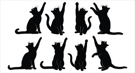 A collection of playful black cat silhouettes with paws raised in various poses © sourov